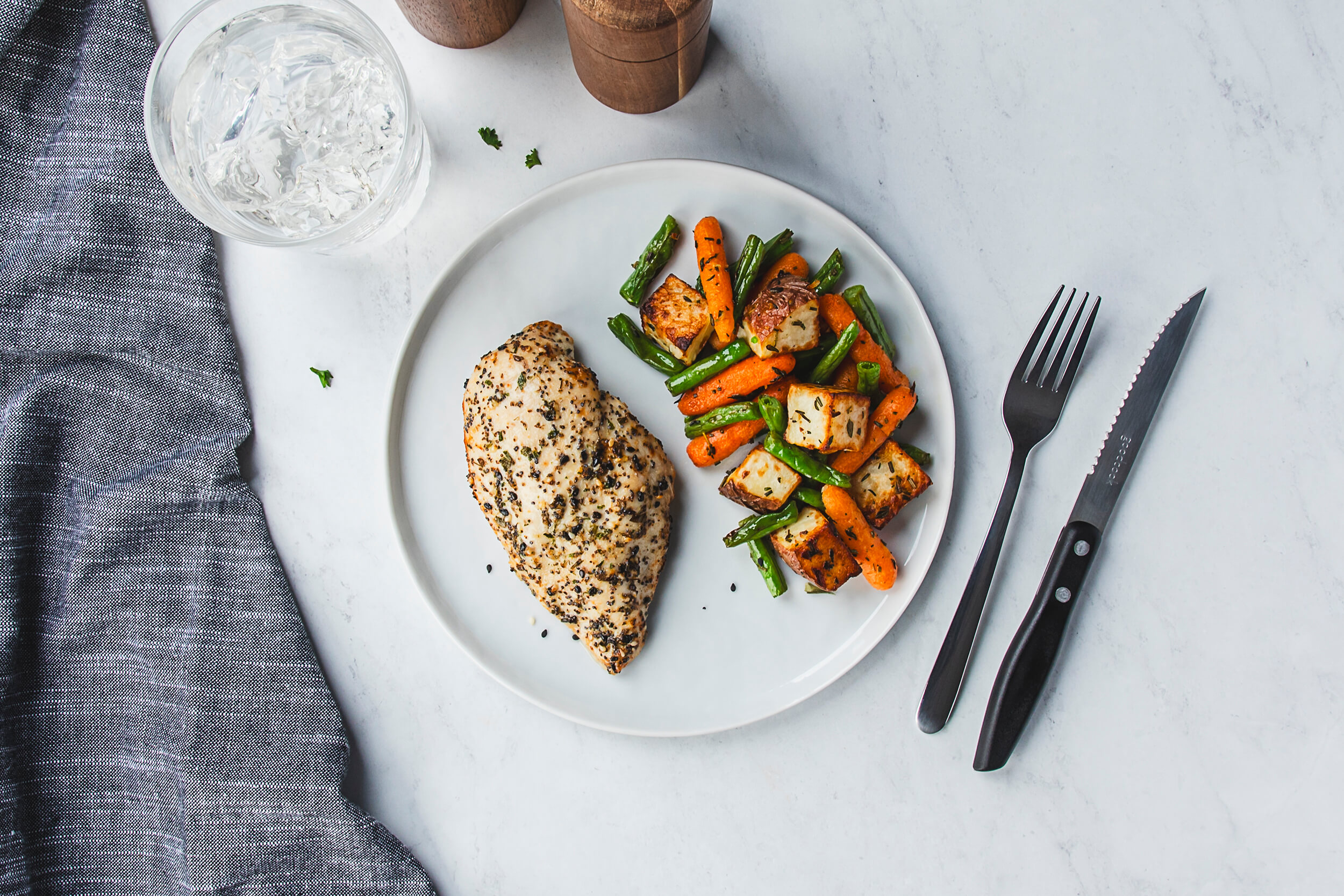 top down view of chicken breast and roasted vegetables