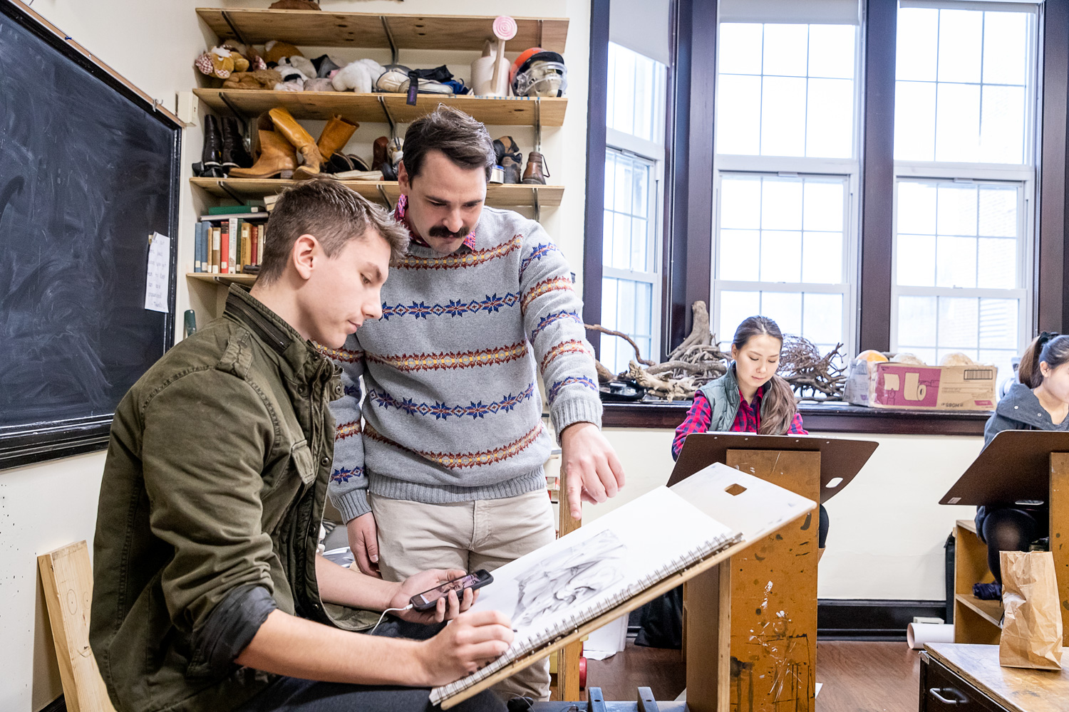 art professor and student in classroom