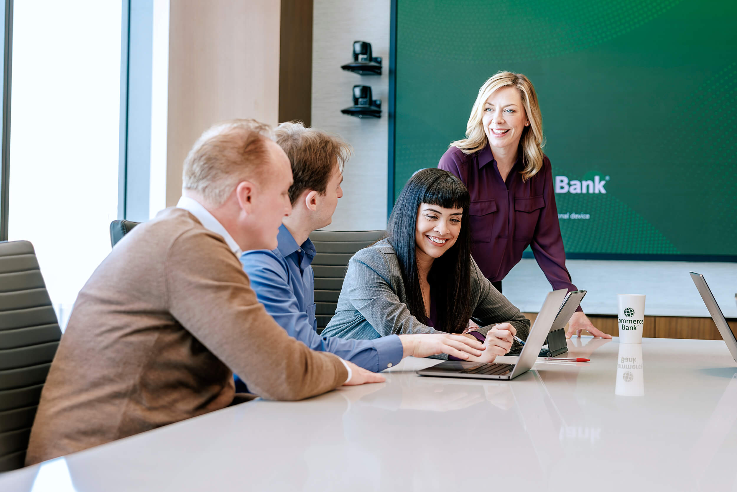office employees looking over a laptop