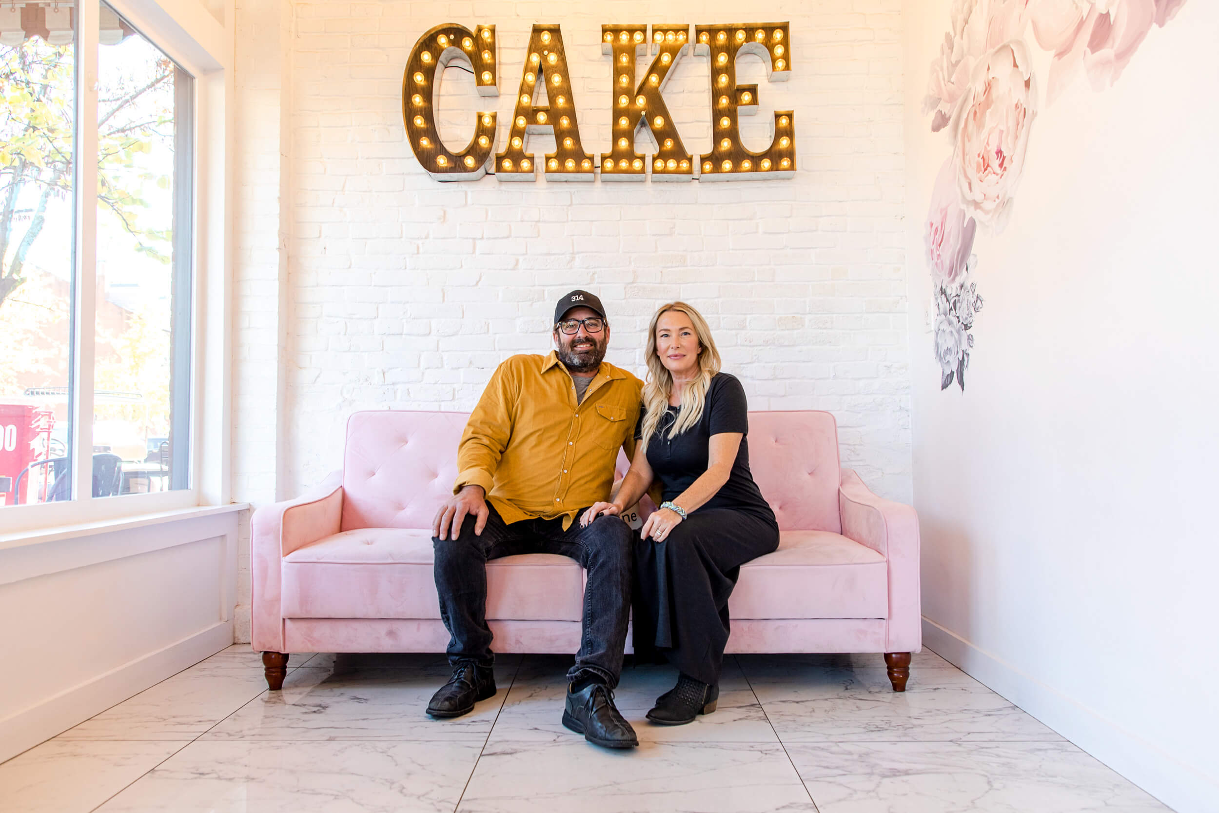 portrait of couple inside their bakery shop