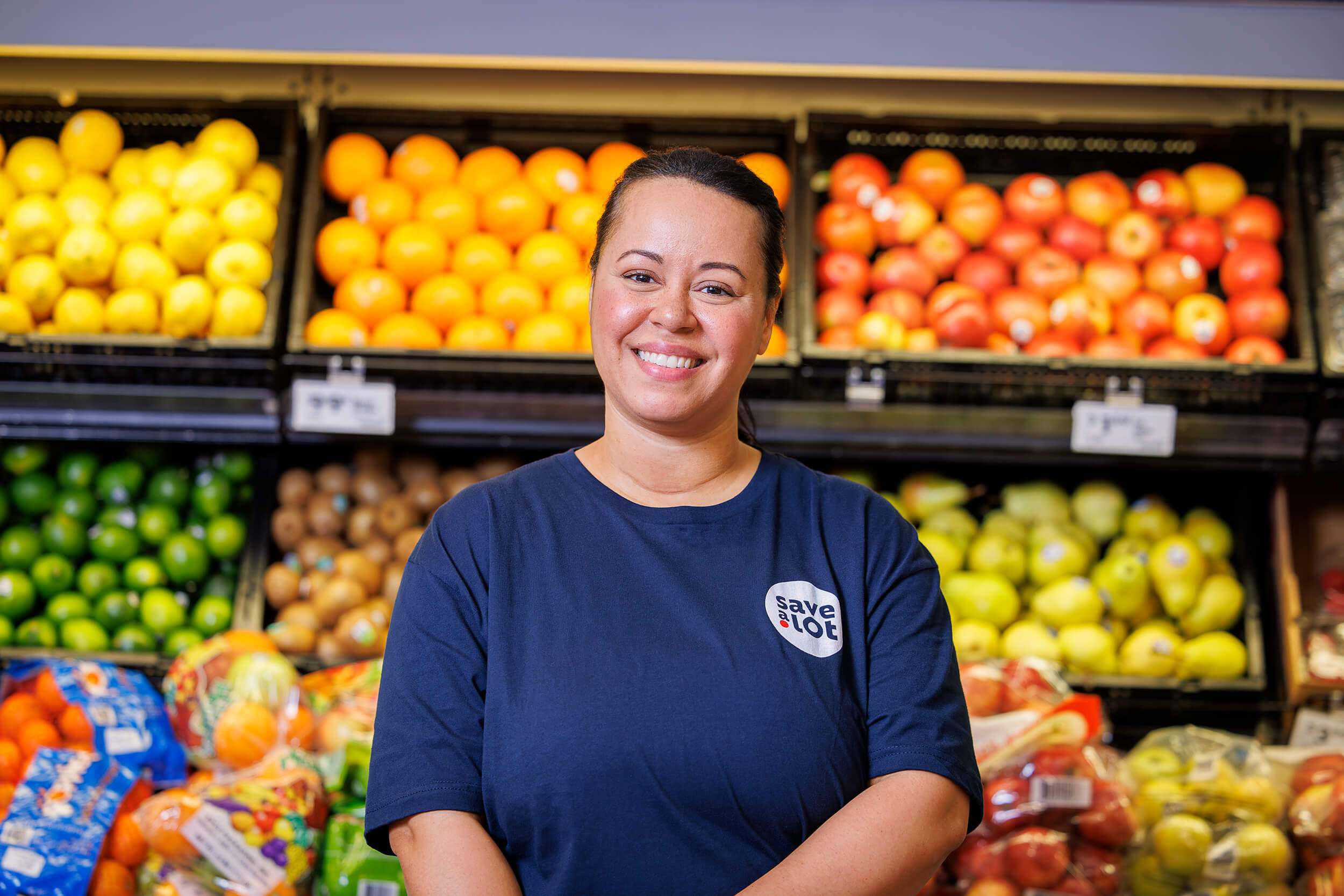 grocery store employee smiling into camera