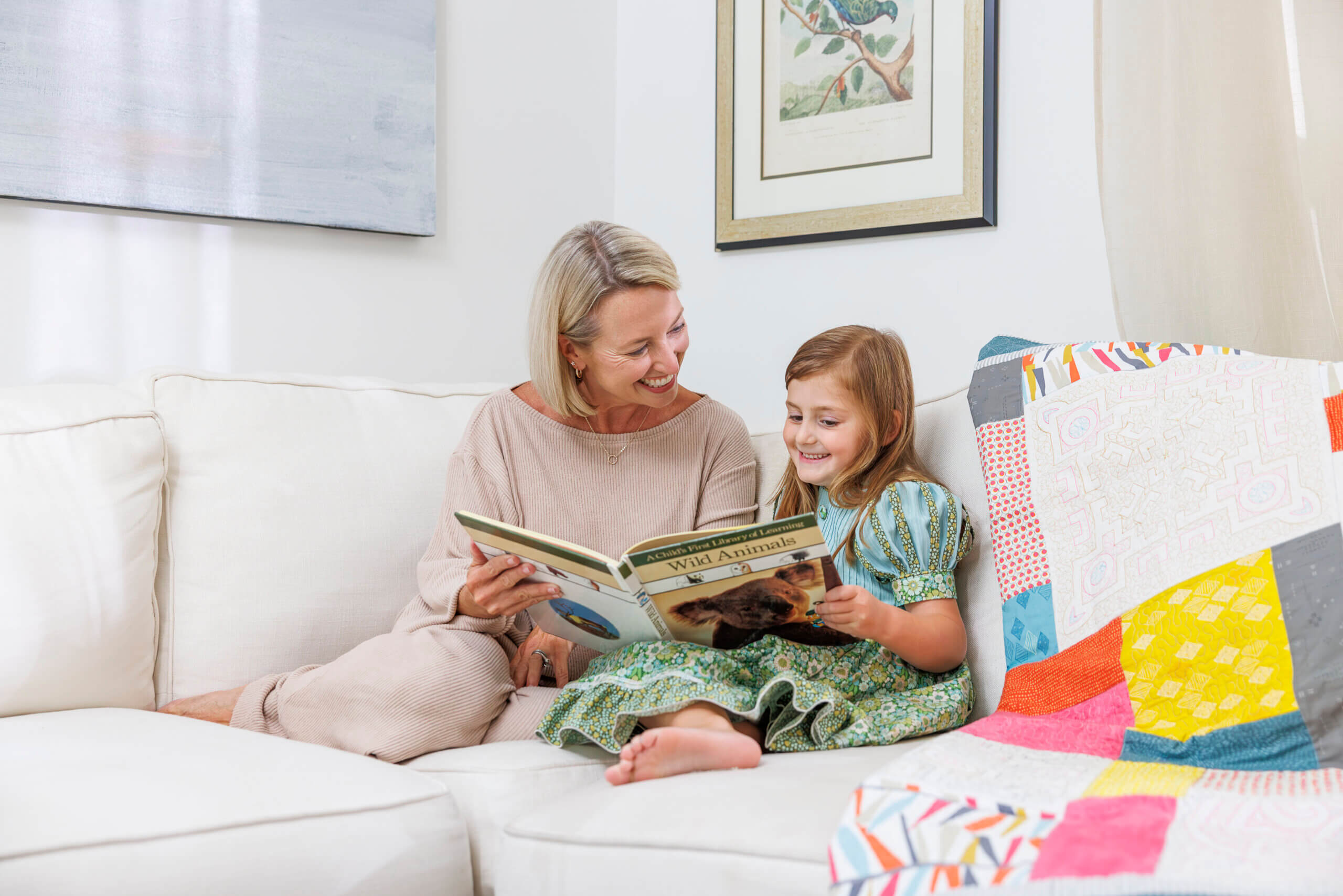 woman reading book to her granddaughter