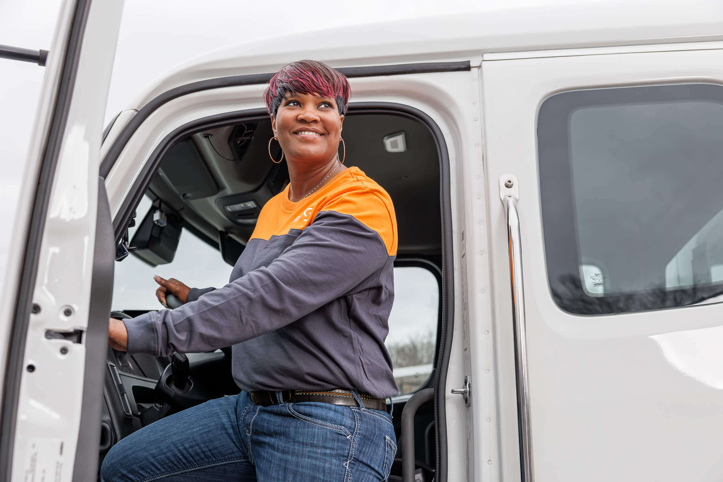 portrait of woman coming out of service van