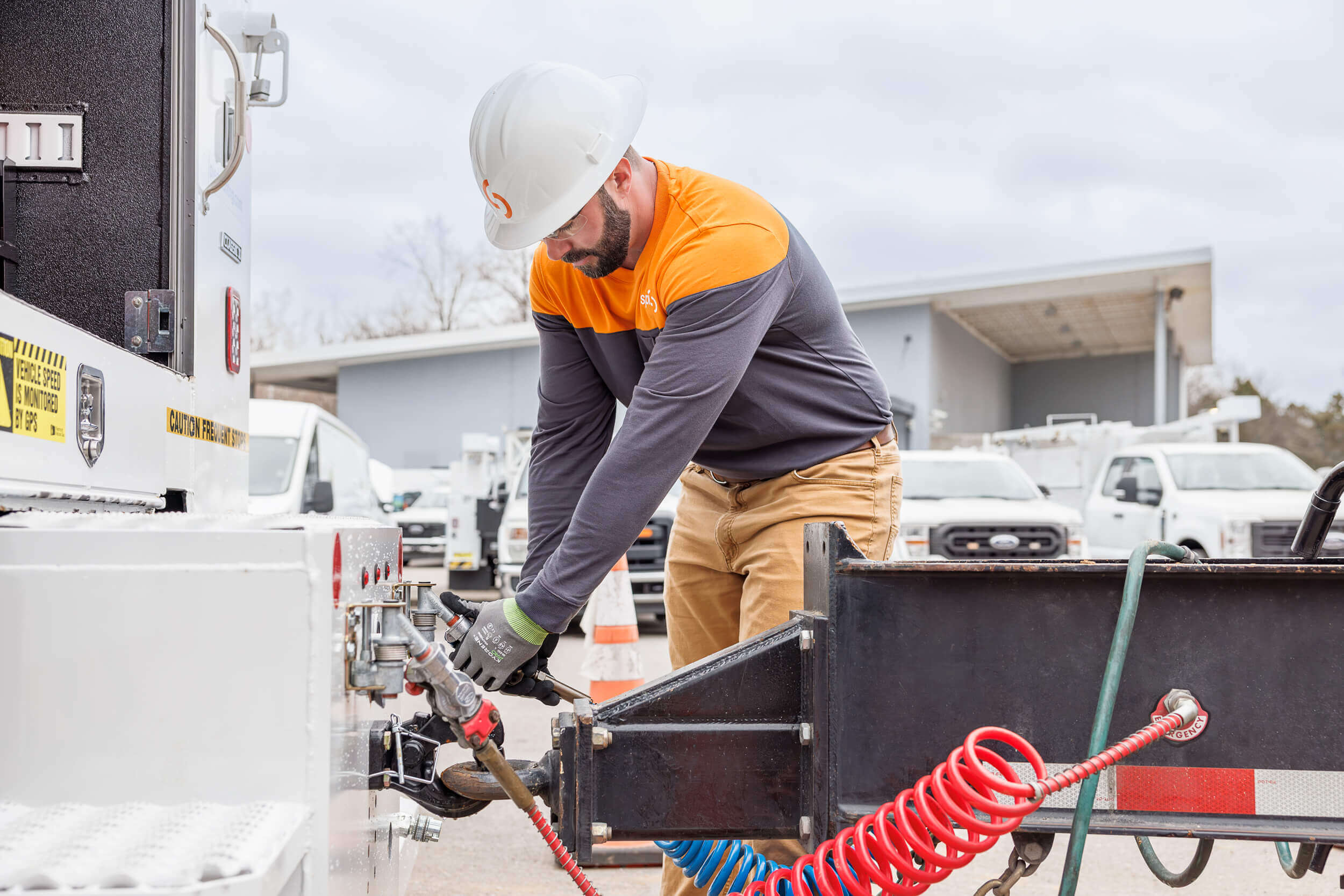 man connecting trailer for service call
